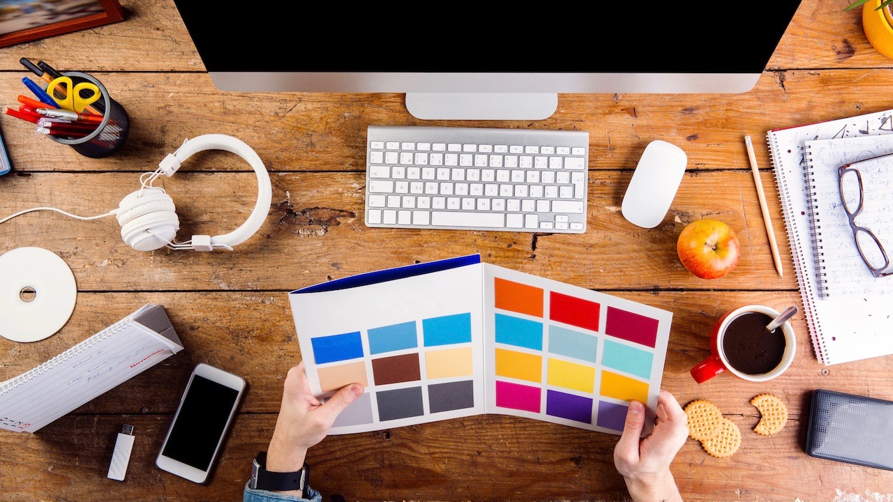 Designer at office desk working with color swatches